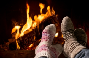 feet in wool socks warming by fire