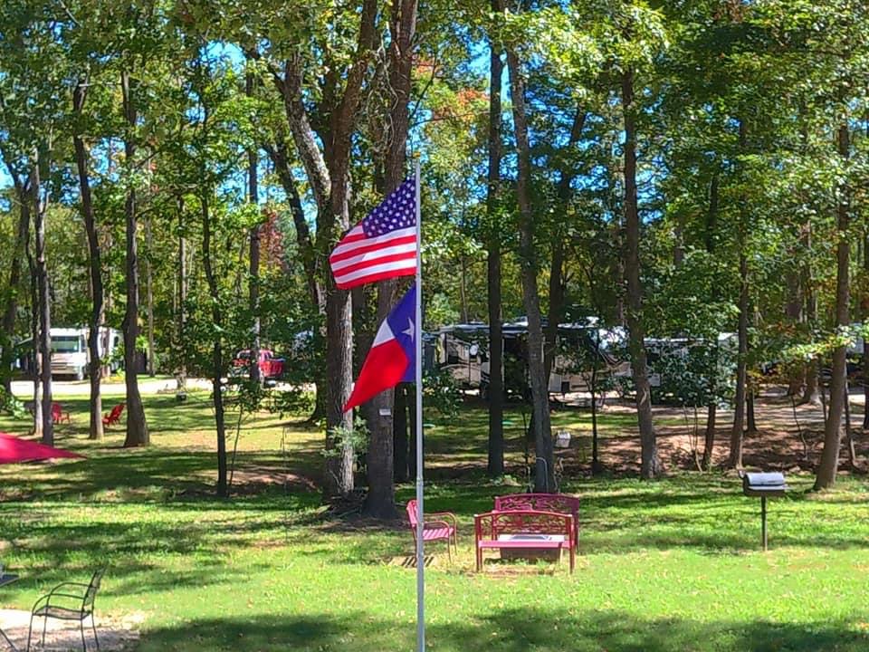 About Us Flag Somgbird RV Park Texas